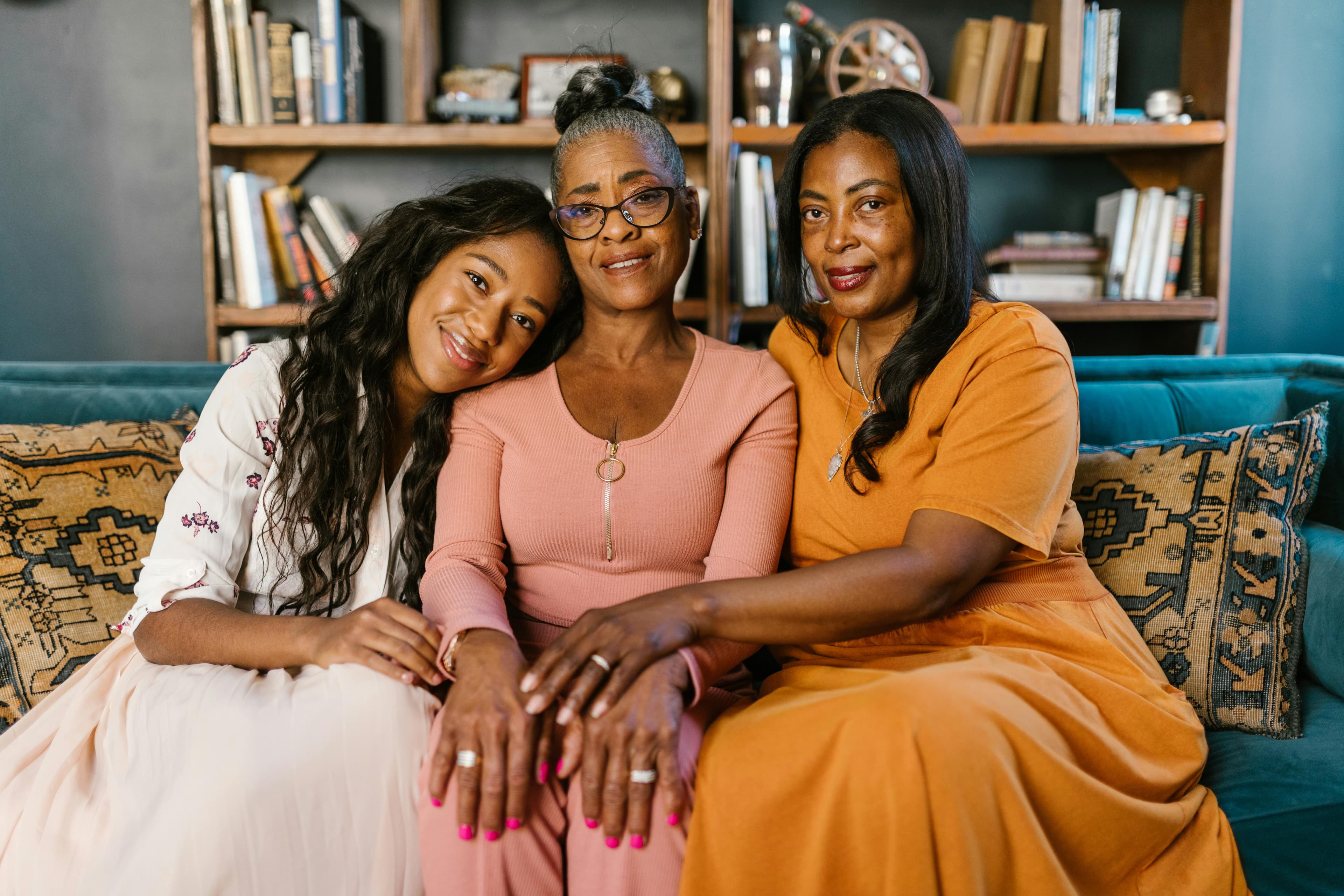 Three generations of Black women, connected, warm, and present