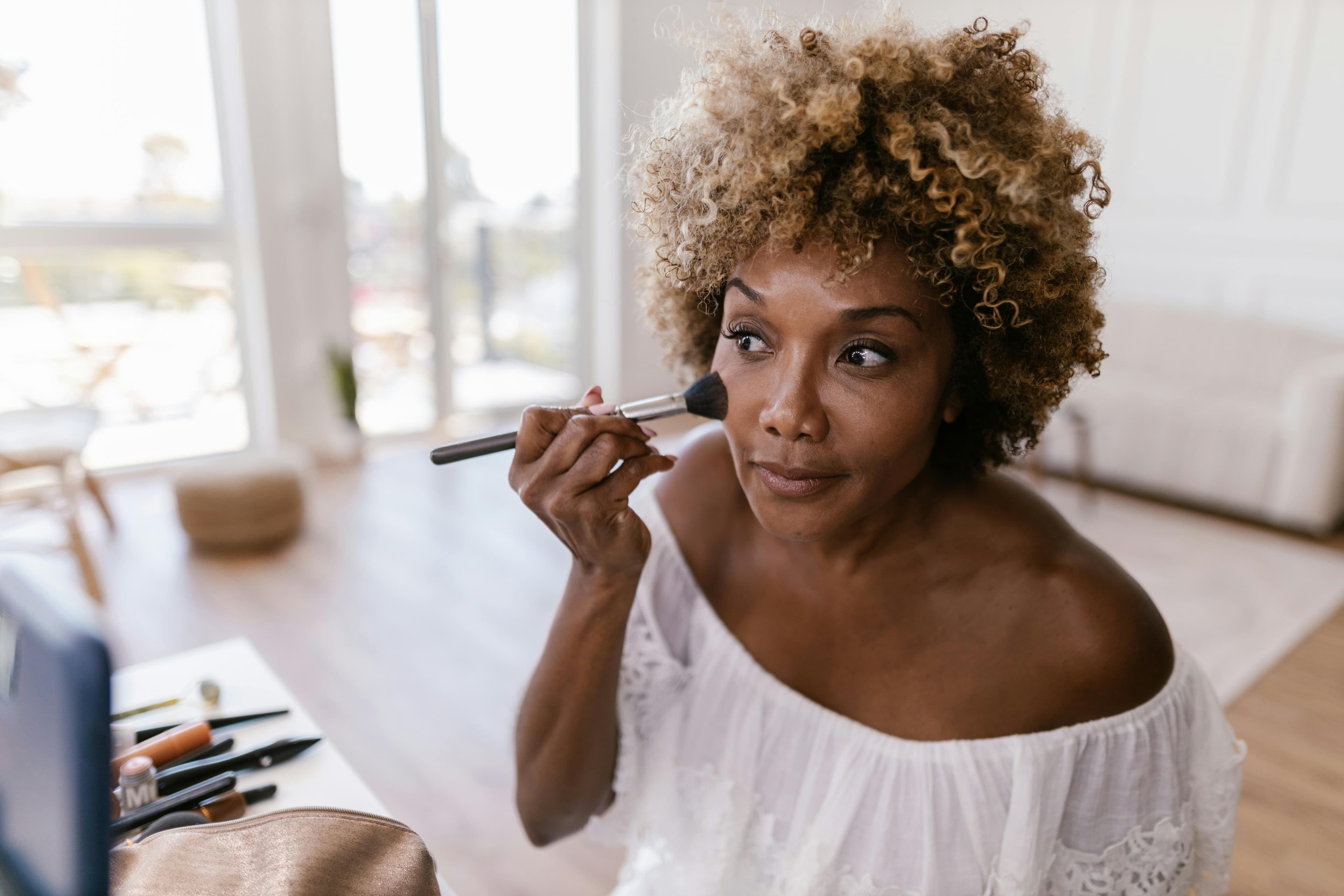 Woman applying makeup, a quiet moment of self-care